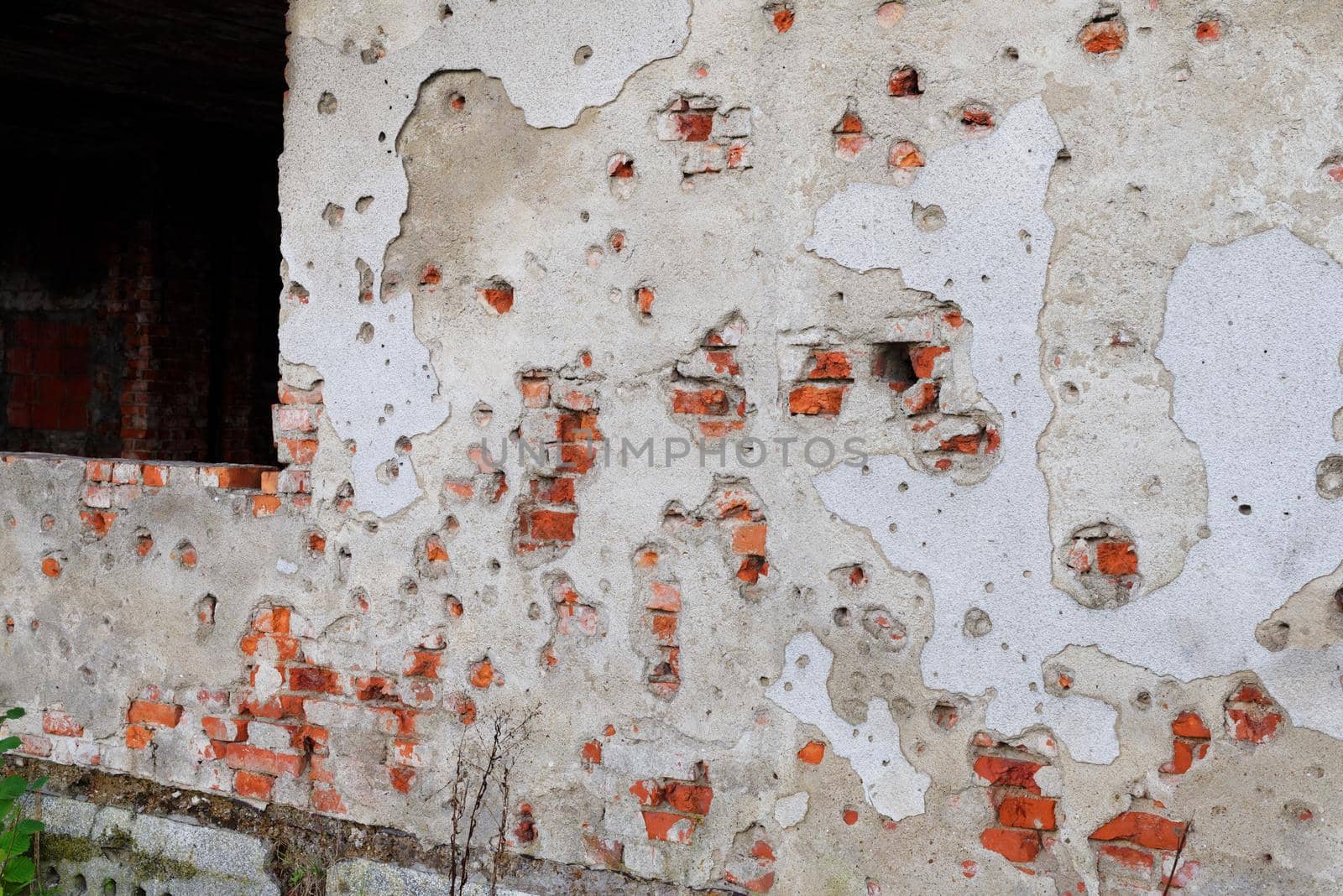 Old brick plastered wall with bullet marks in Karlovac War museum, Croatia by slavapolo