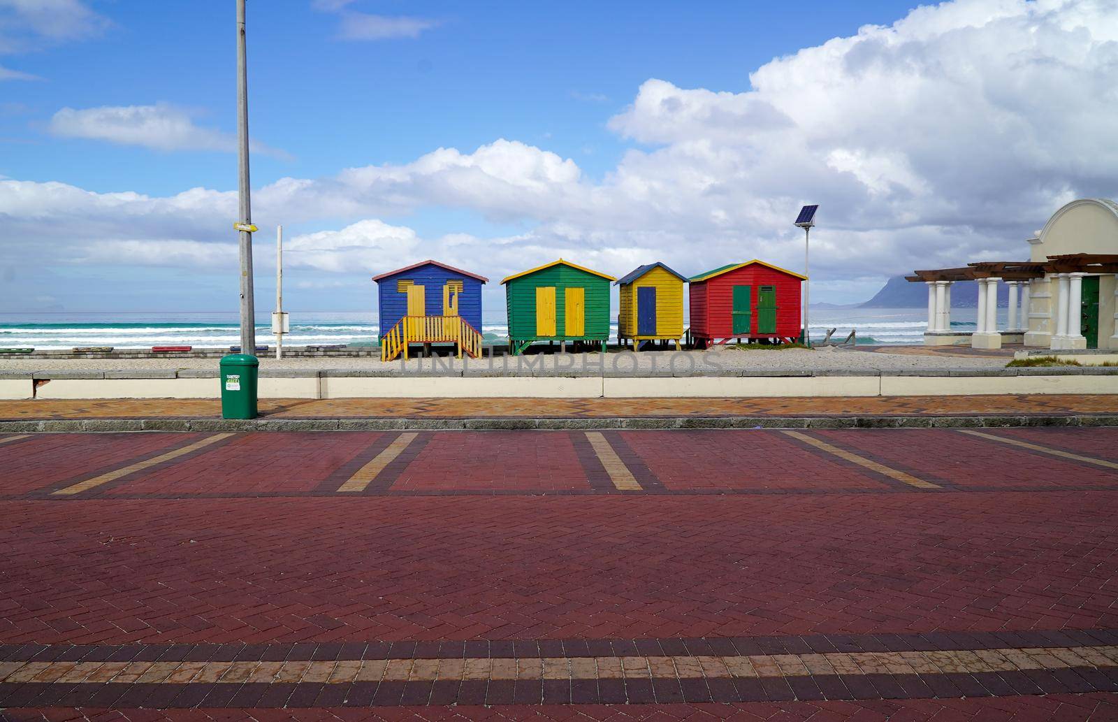 Cape Town, South Africa - 16 April 2020 : Empty parking lot and beach at Muizenberg in Cape town, South Africa during the lock down. by fivepointsix