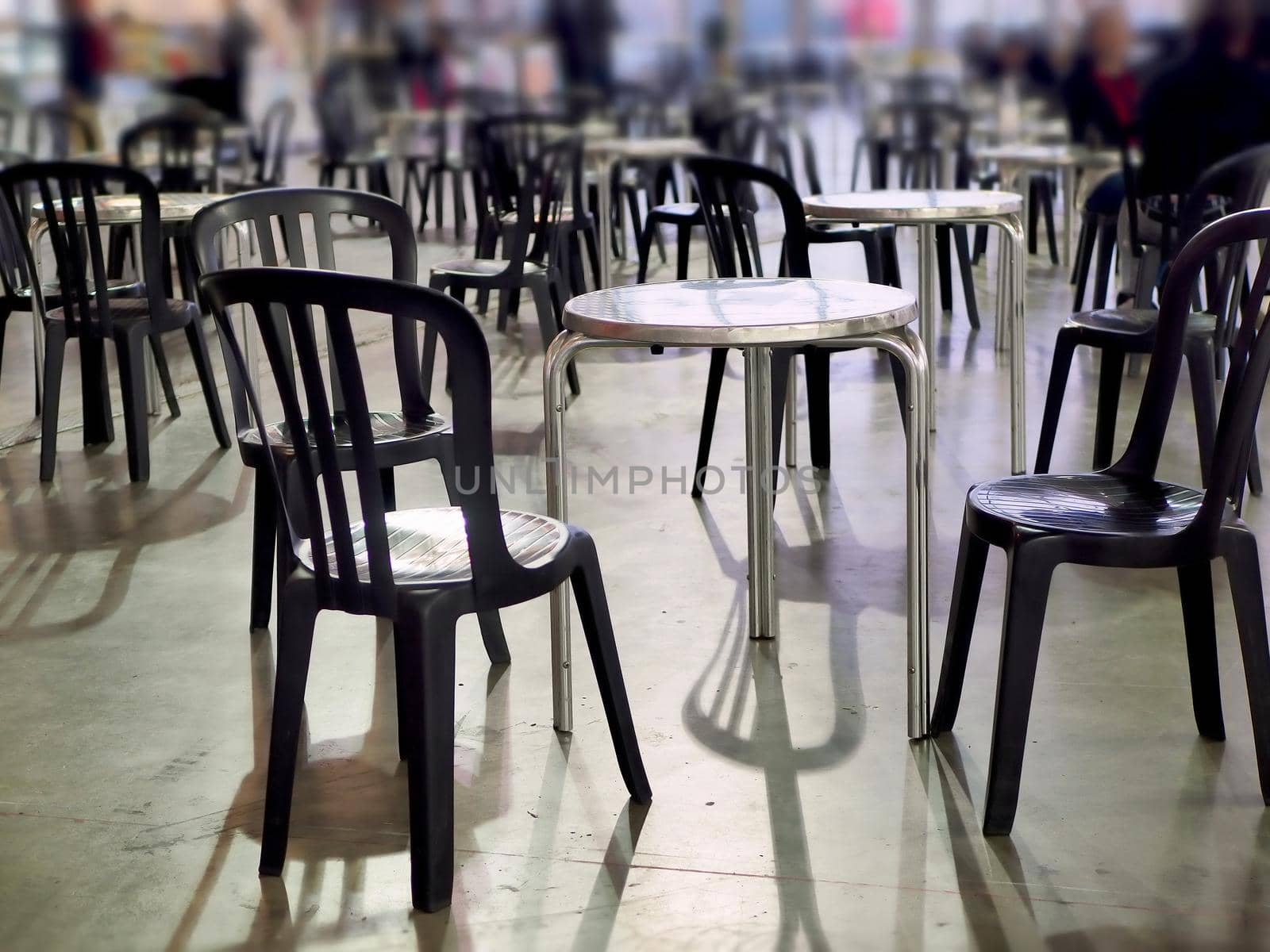 Empty tables of a bar terrace narrow foreground focus