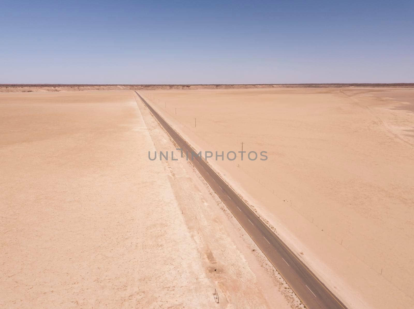 Aerial of desert road through arid landscape by fivepointsix
