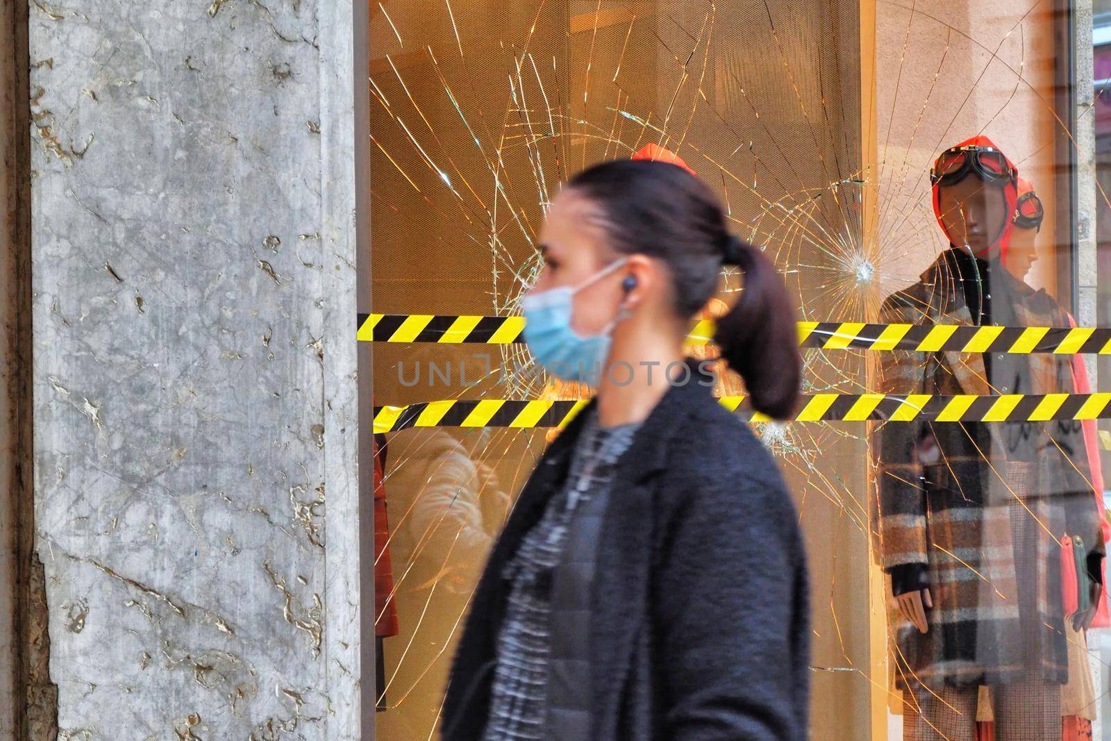 Fashion retail store glass window damaged during the riot protest against lockdown and related economic crisis Turin, Italy November 2 2020 deliberate selective focus on background by lemar
