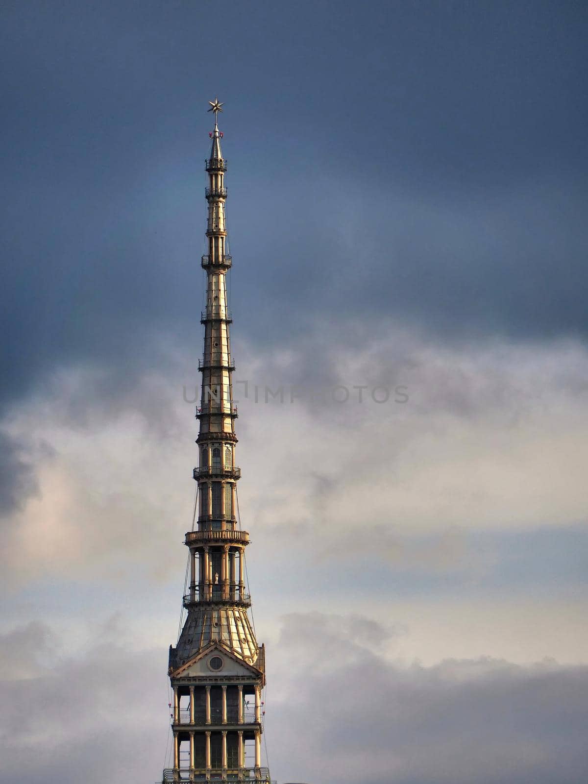 Scenic view of the spire of one of the city symbols, the mole antonelliana, from piazza castello under cloudy stormy sky Turin Italy October 10 2020