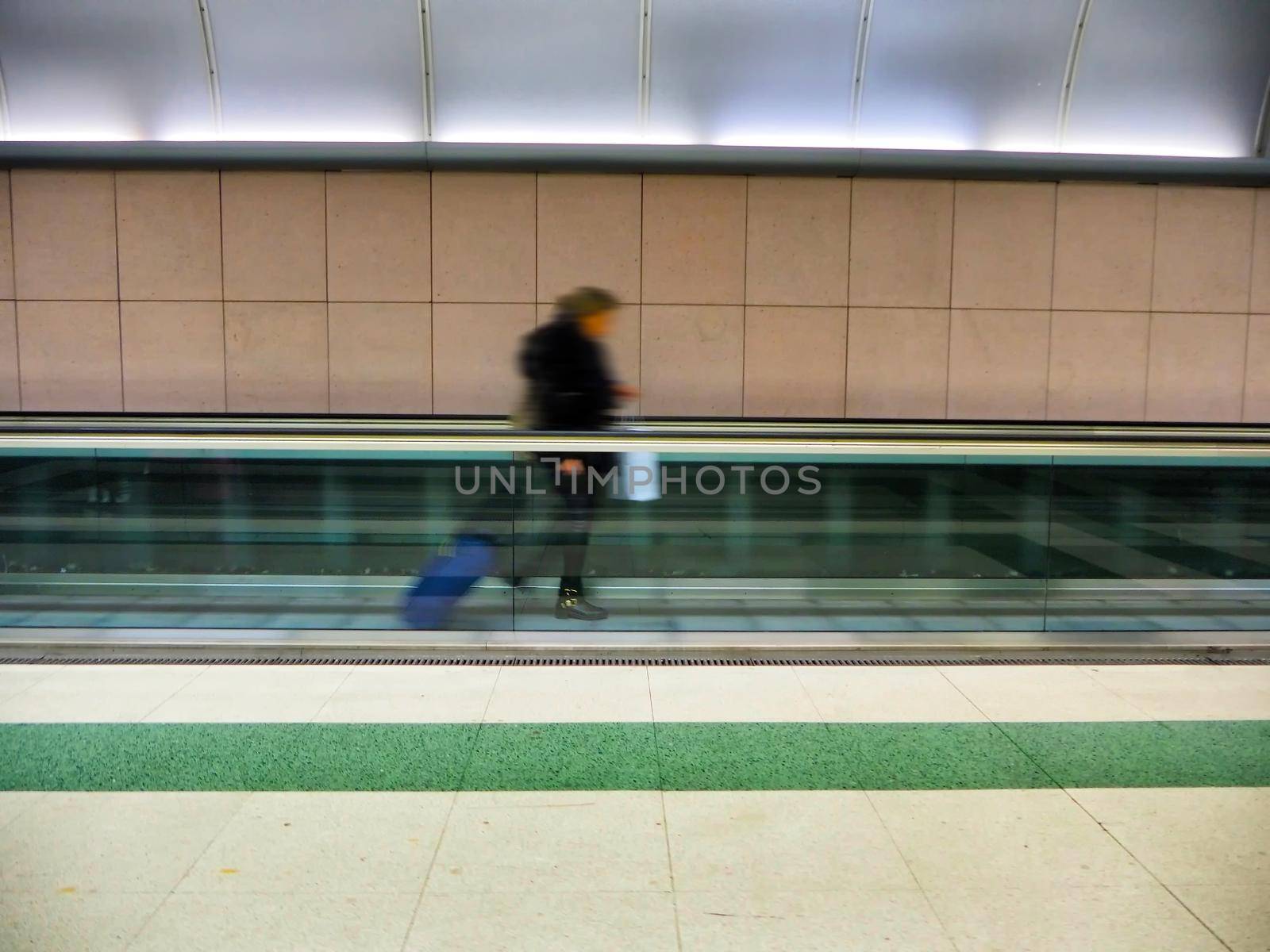 Unrecognizable traveler on hurry motion effect of blurred person alone Milan Italy February 5 2020 by lemar