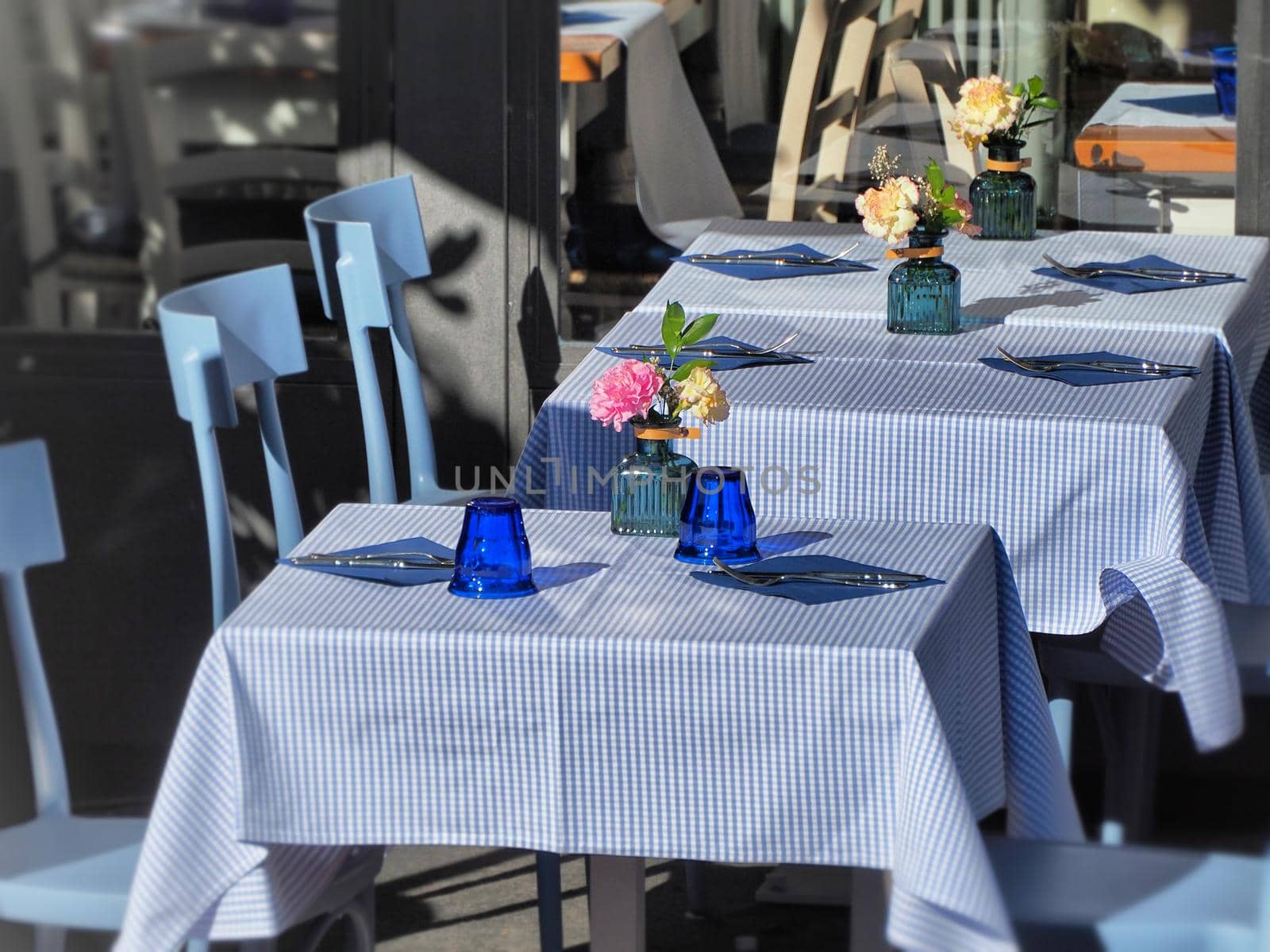 Close up view of outdoor tables of restaurant waiting for customers