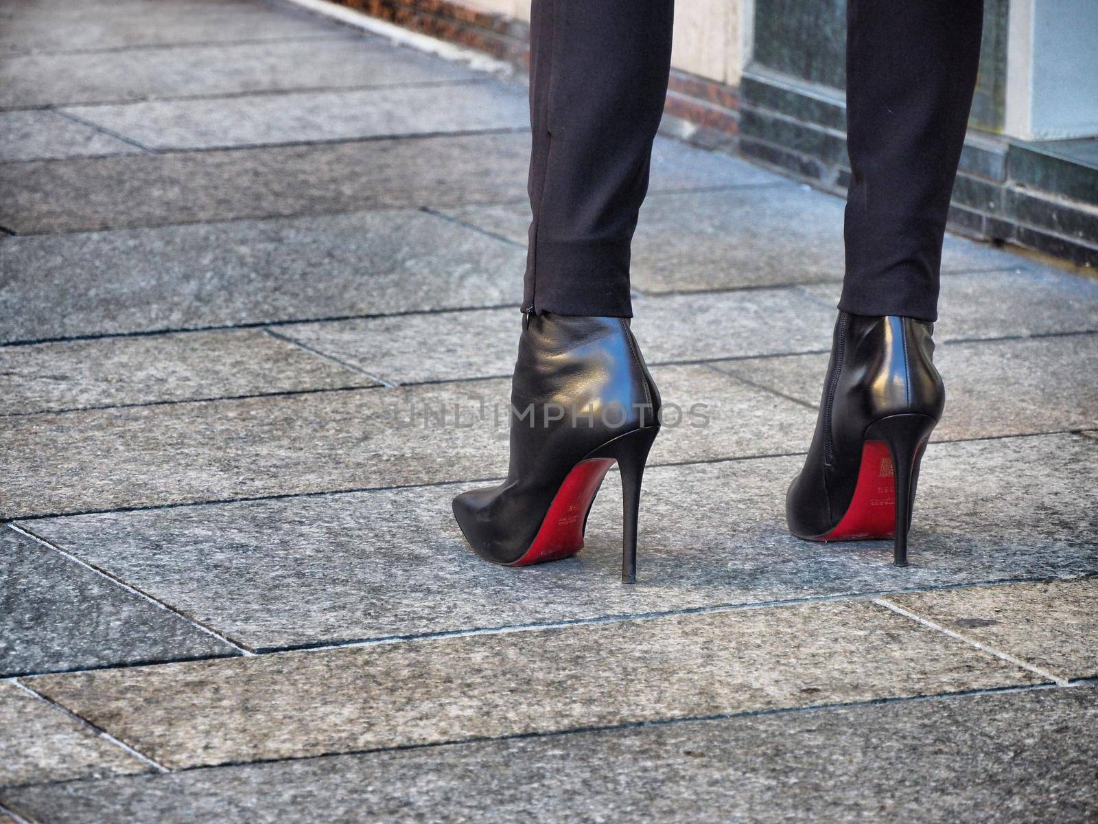 Close up view of woman legs wearing high-heeled shoes by lemar