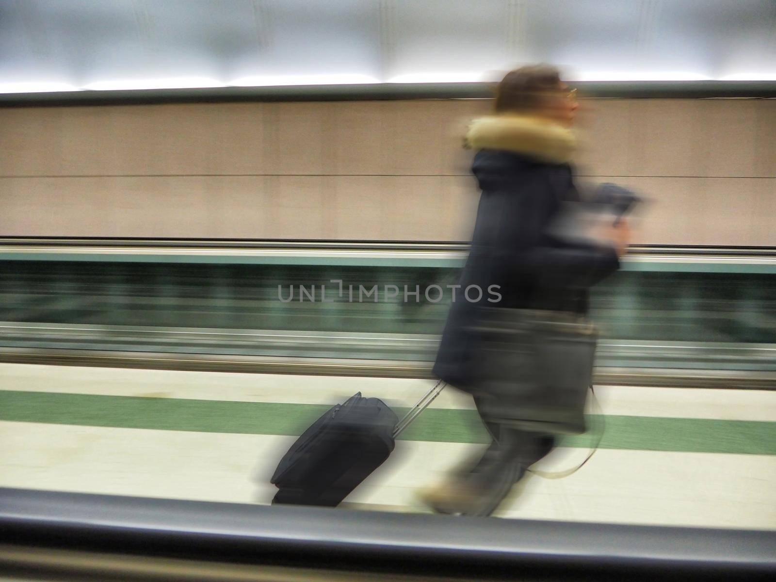 Unrecognizable traveler on hurry motion effect of blurred person alone Milan Italy February 5 2020 by lemar