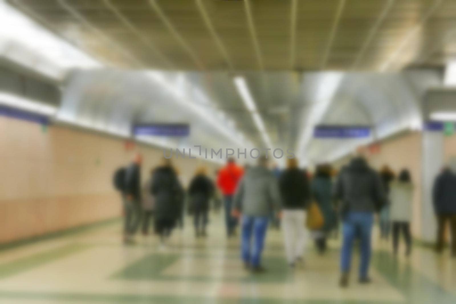 Busy station corridor with unrecognizable blurred crowd