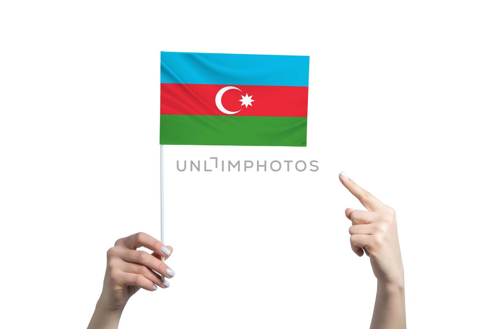 A beautiful female hand holds a Azerbaijan flag to which she shows the finger of her other hand, isolated on white background.