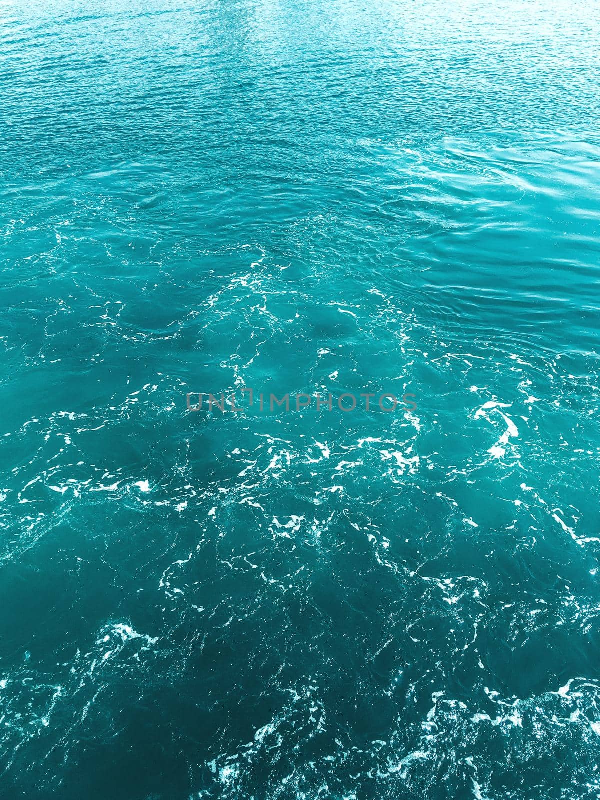 Blue water with foam waves. Deep sea. Peaceful ocean. Abstract natural background. by aksenovko