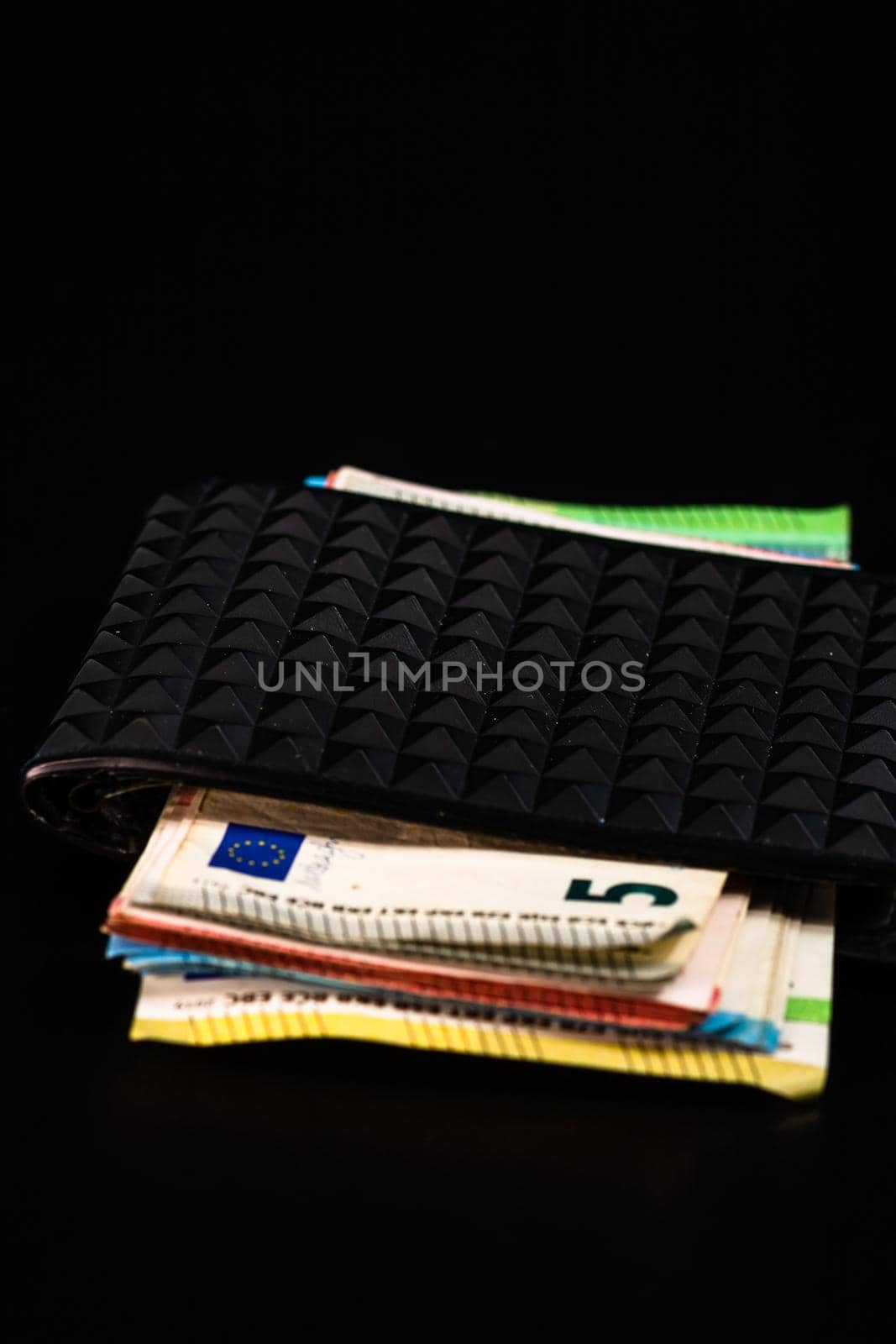 Euro banknotes in black wallet isolated.