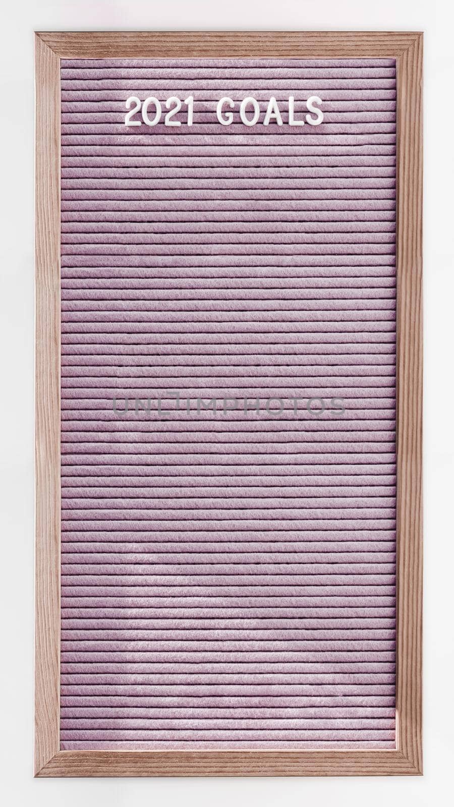 Long pink vertical letter board with words 2021 GOALS. New Year promises and resolutions. Copy space on pink felt background. Vertical banner 9:16.