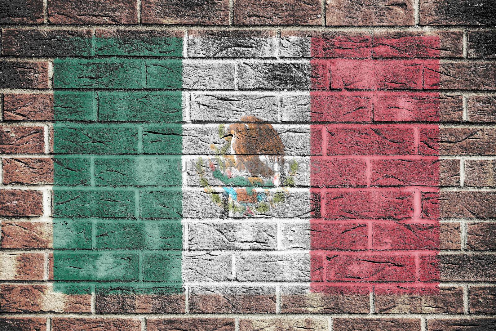 A Mexico flag on old brick wall background
