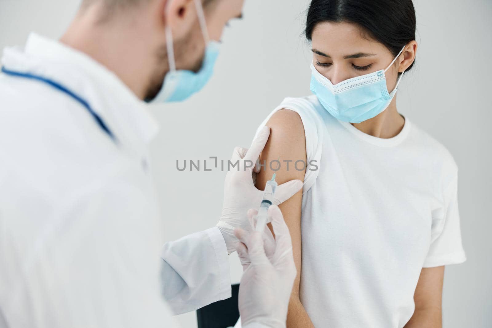 vaccination injection patient in medical mask in hospital and doctor. High quality photo