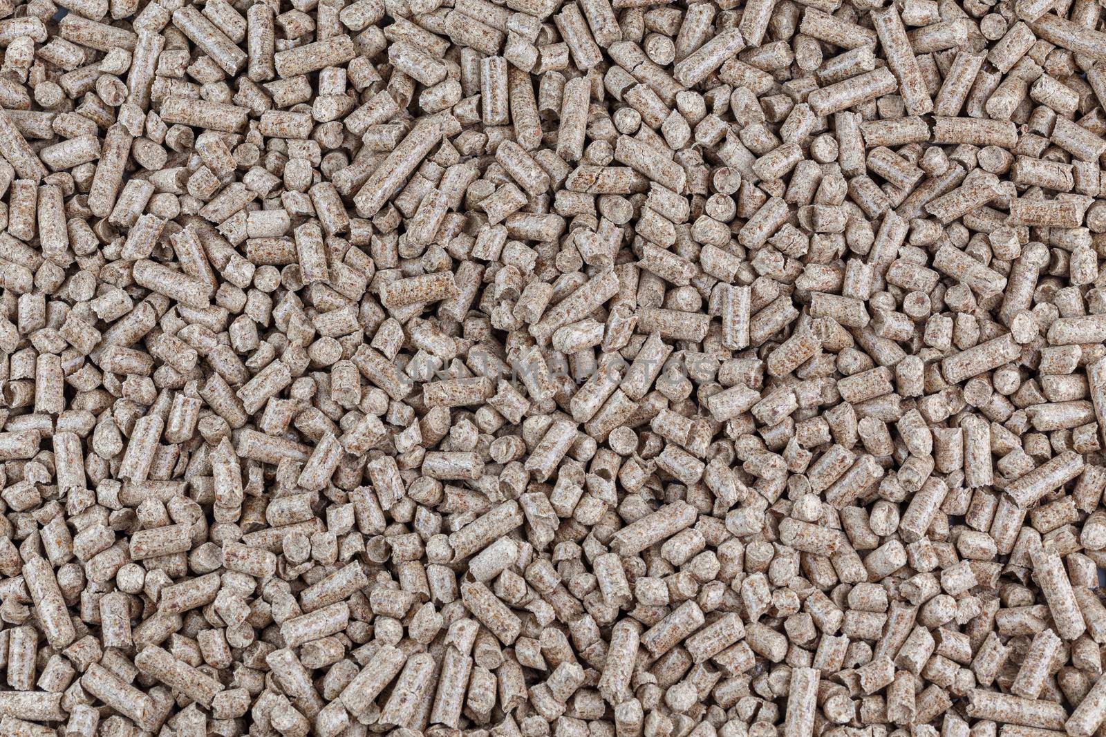 Compressed wooden sawdust pellets texture and background. Alternative biofuel and pet litter, mulch.