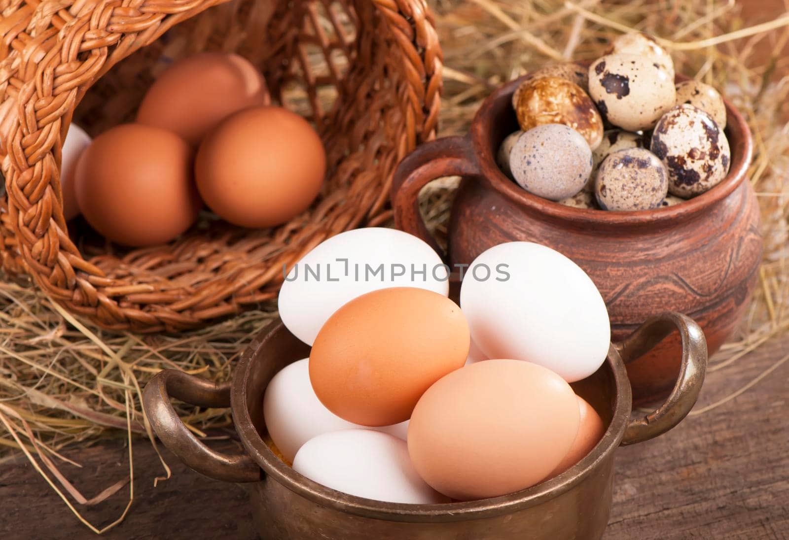 Chicken eggs in basket on wooden background by aprilphoto