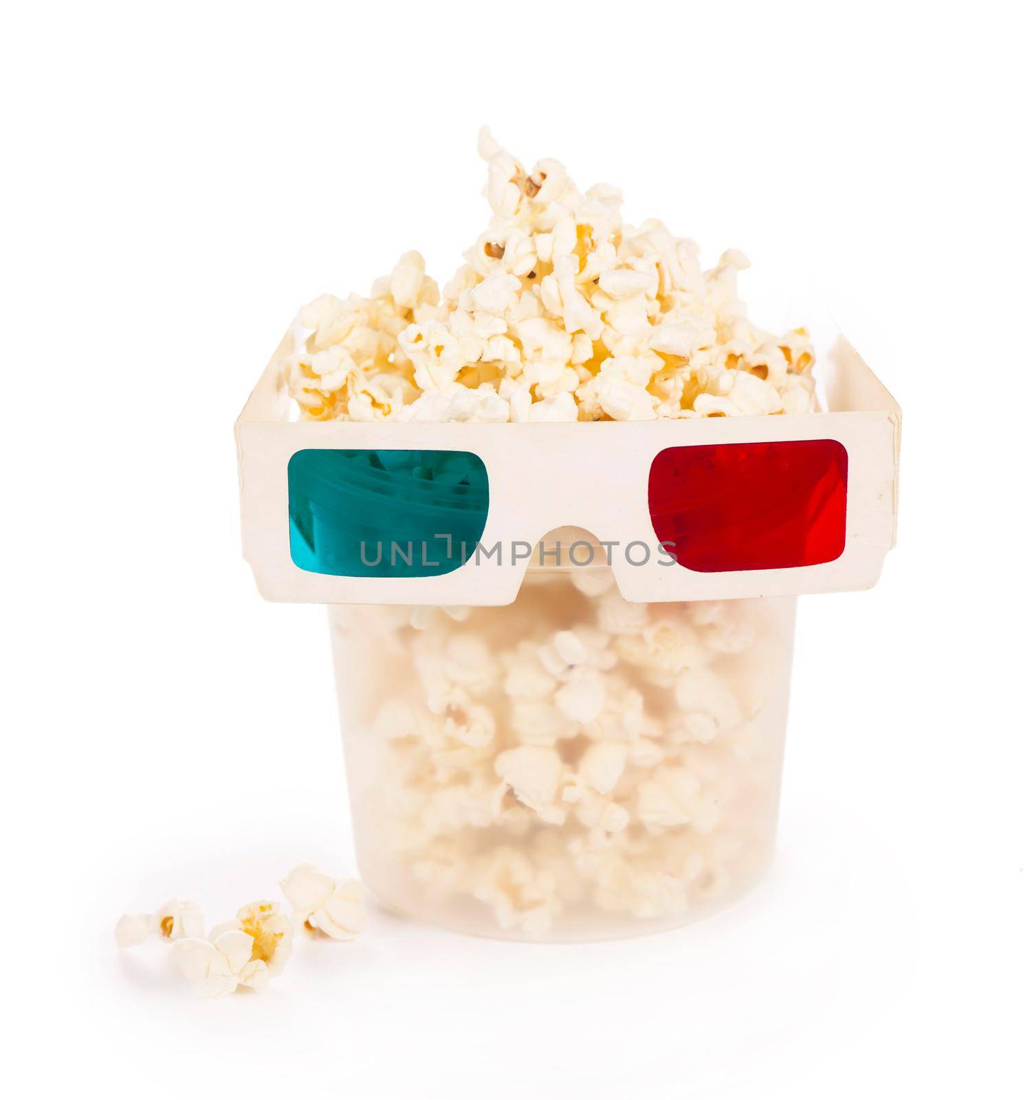 Paper striped bucket with popcorn and 3D glasses isolated on white background with clipping path. Concept of cinema or watching TV. by aprilphoto