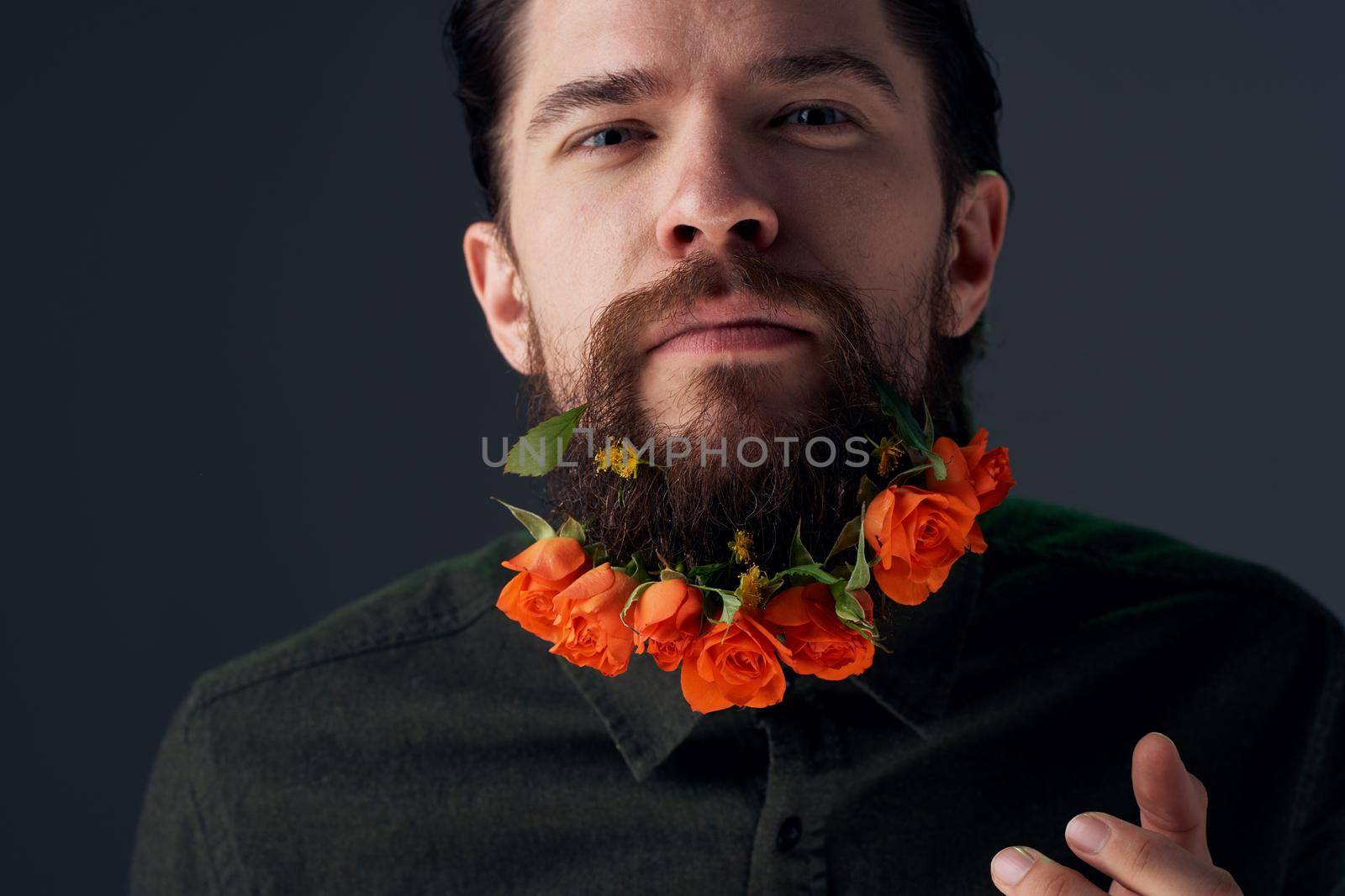 emotional man flowers in a beard gift romance decoration studio. High quality photo