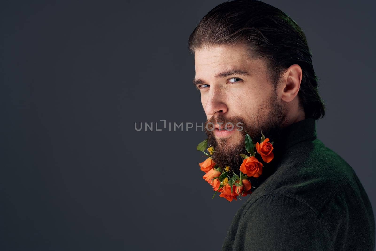 Cute man flowers in beard ornaments elegant style close-up. High quality photo