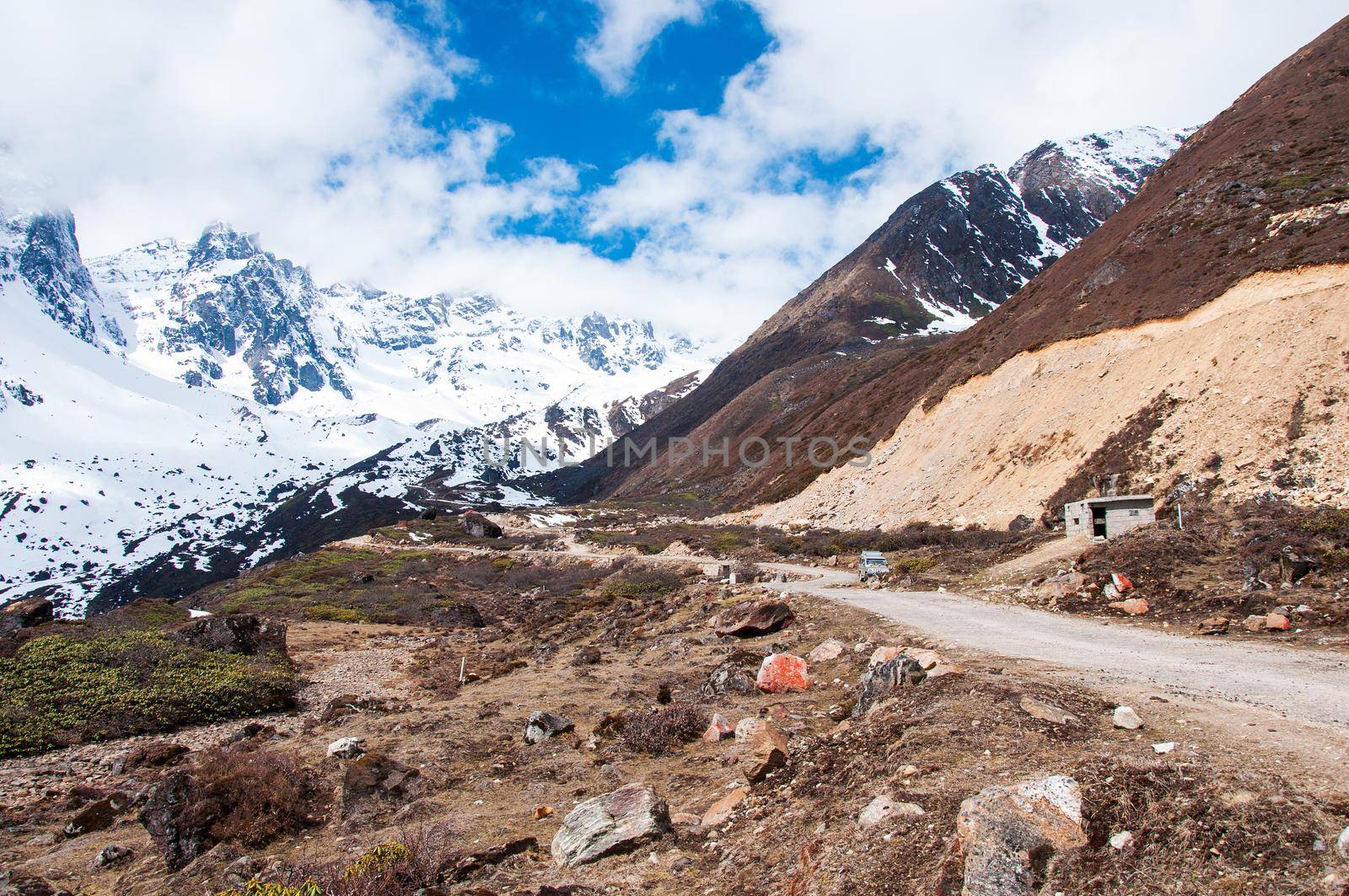 Beautiful landscape of Chopta valley with Snow covered beautiful mountain peaks against the blue sky at north Sikkim India