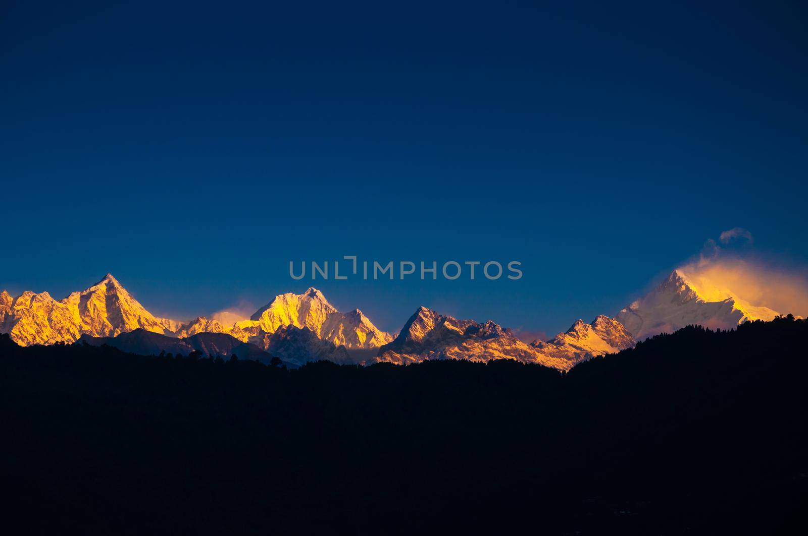 The majestic Kanchenjunga range of the himalayas at first light of sunrise at Sikkim , India