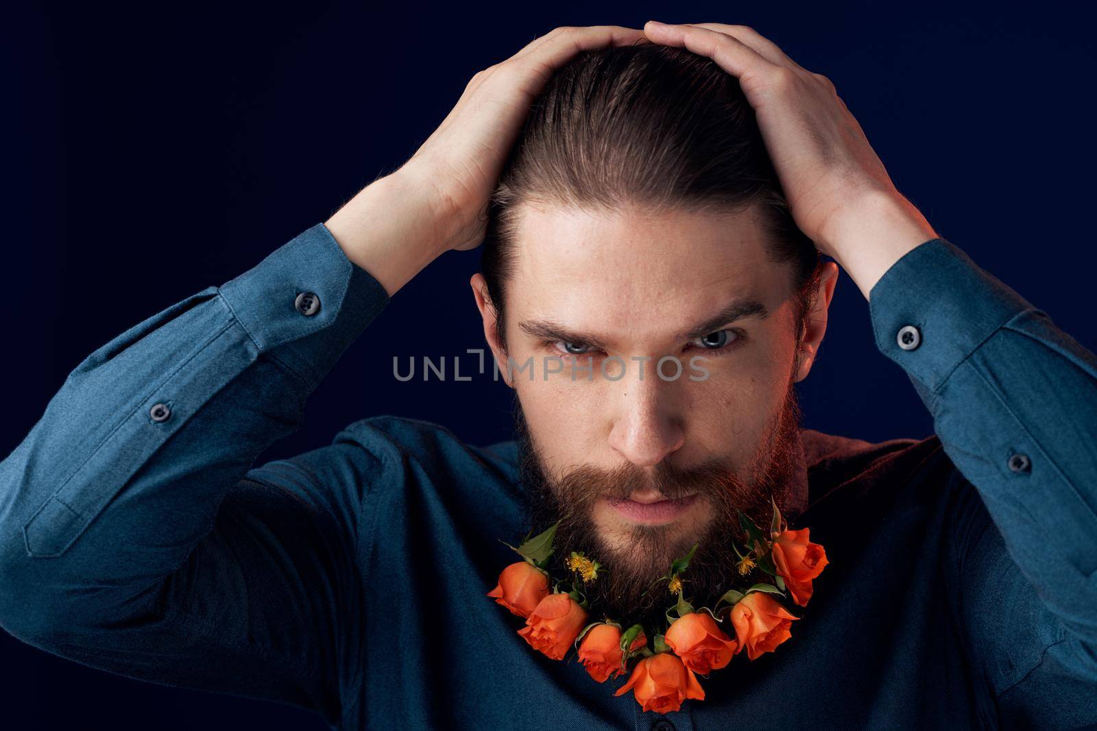 Bearded man flowers in a beard close-up romance dark background by SHOTPRIME