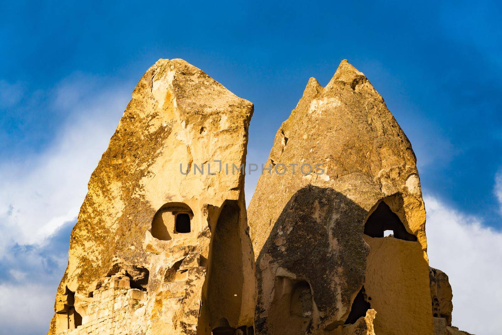 Ancient rock with blue sky background at Goreme, Cappadocia in Central Anatolia, Turkey by Nuamfolio