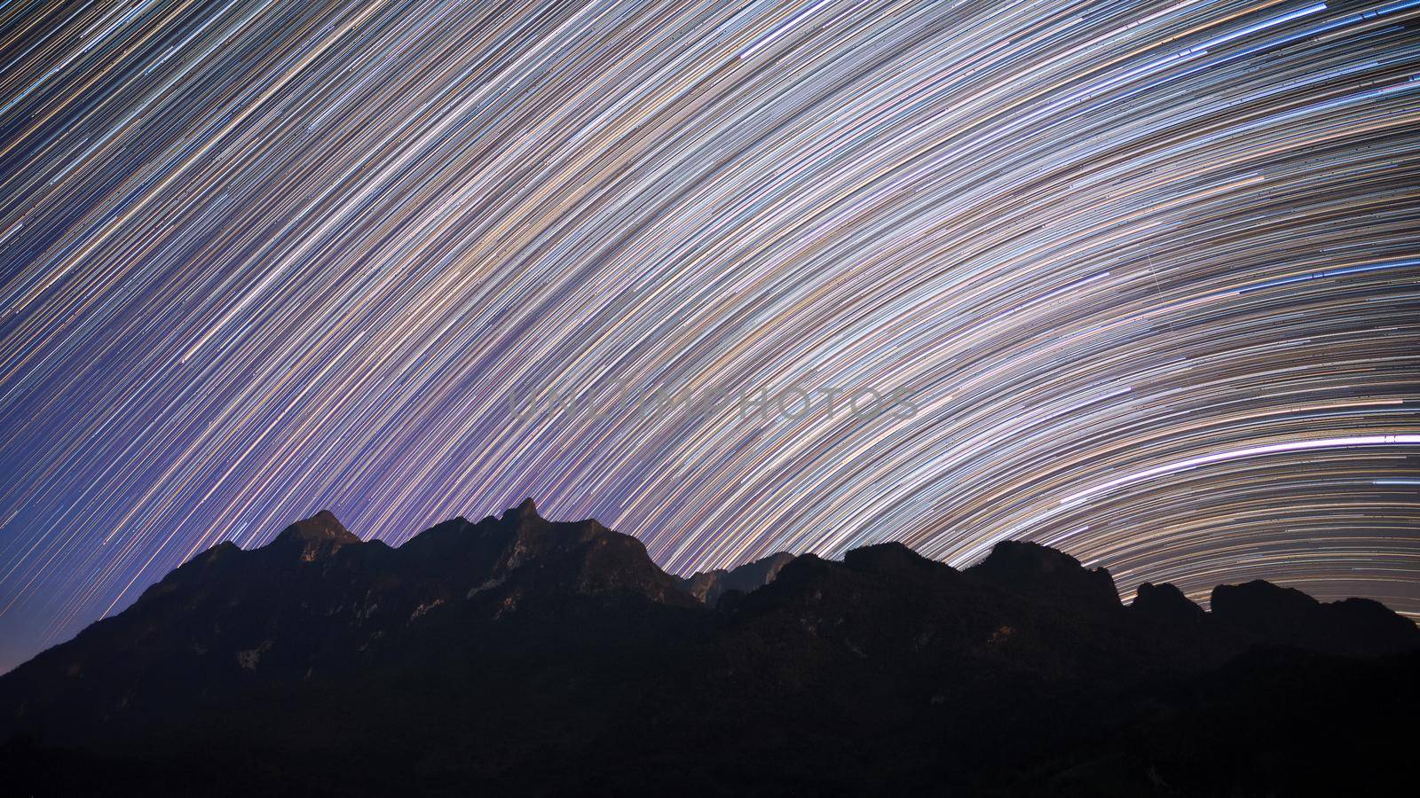 Star trails over Doi Luang Chiang Dao mountain at night, The famous mountain for tourist to visit in Chiang Mai,Thailand. by Nuamfolio