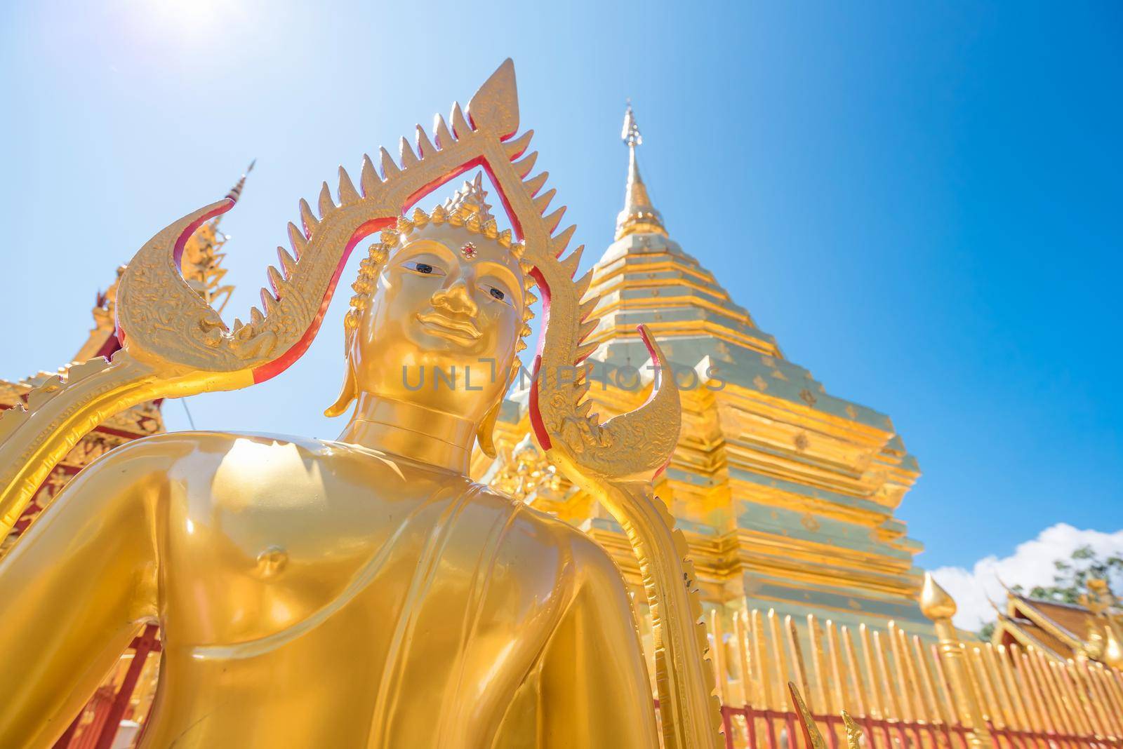 Buddha statue at Wat Phra That Doi Suthep with blue sky in Chiang Mai. The attractive sightseeing place for tourists and landmark of Chiang Mai,Thailand.