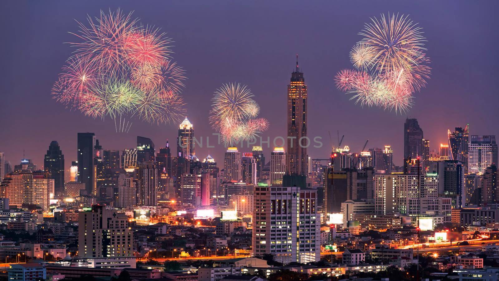 Fireworks light up show on sky over Bangkok City downtown at night,Thailand. Bangkok is the most populated city in Southeast Asia.