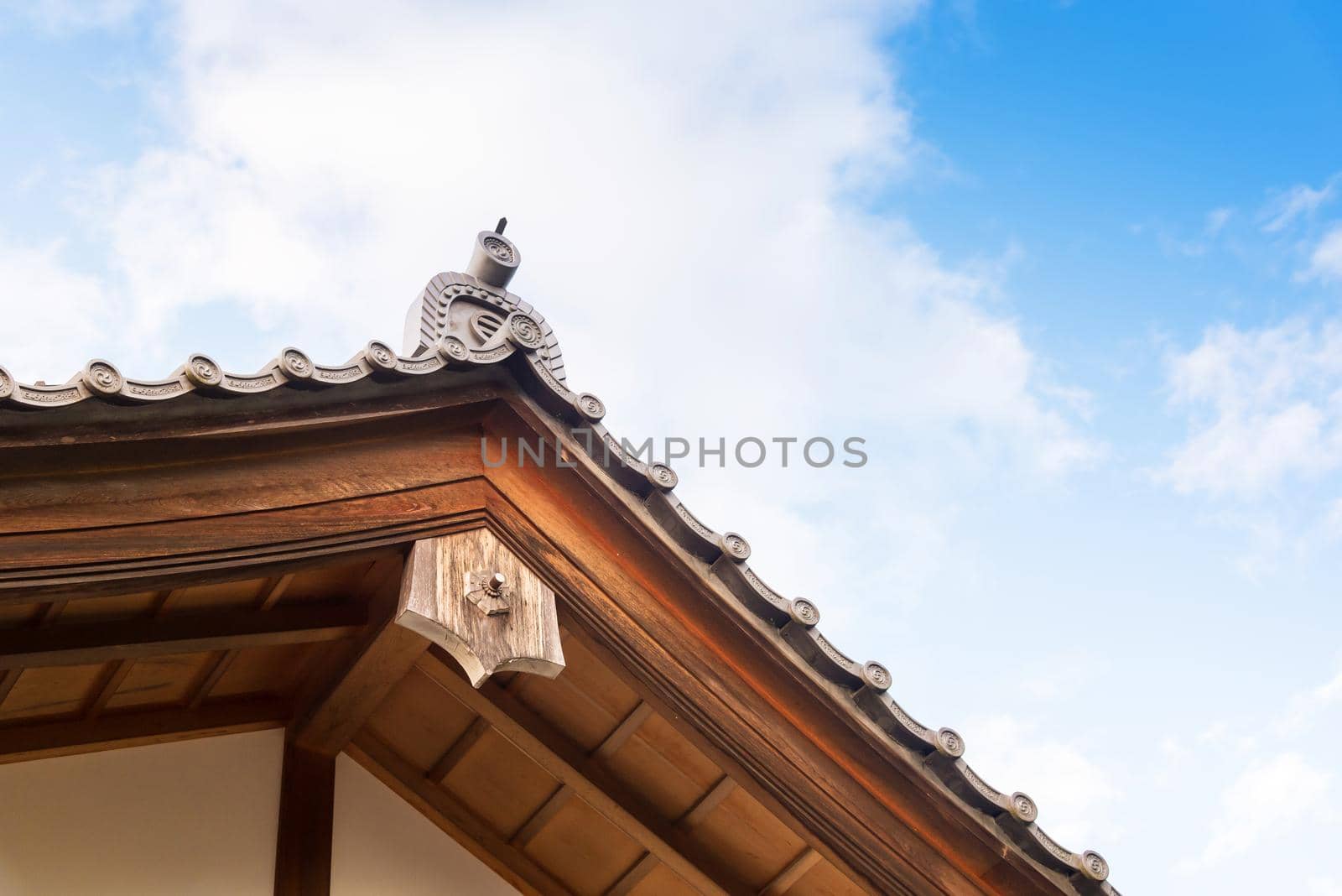 Close up of Japanese tradition roof and wood structure of ancient building in Kyoto, Japan. by Nuamfolio