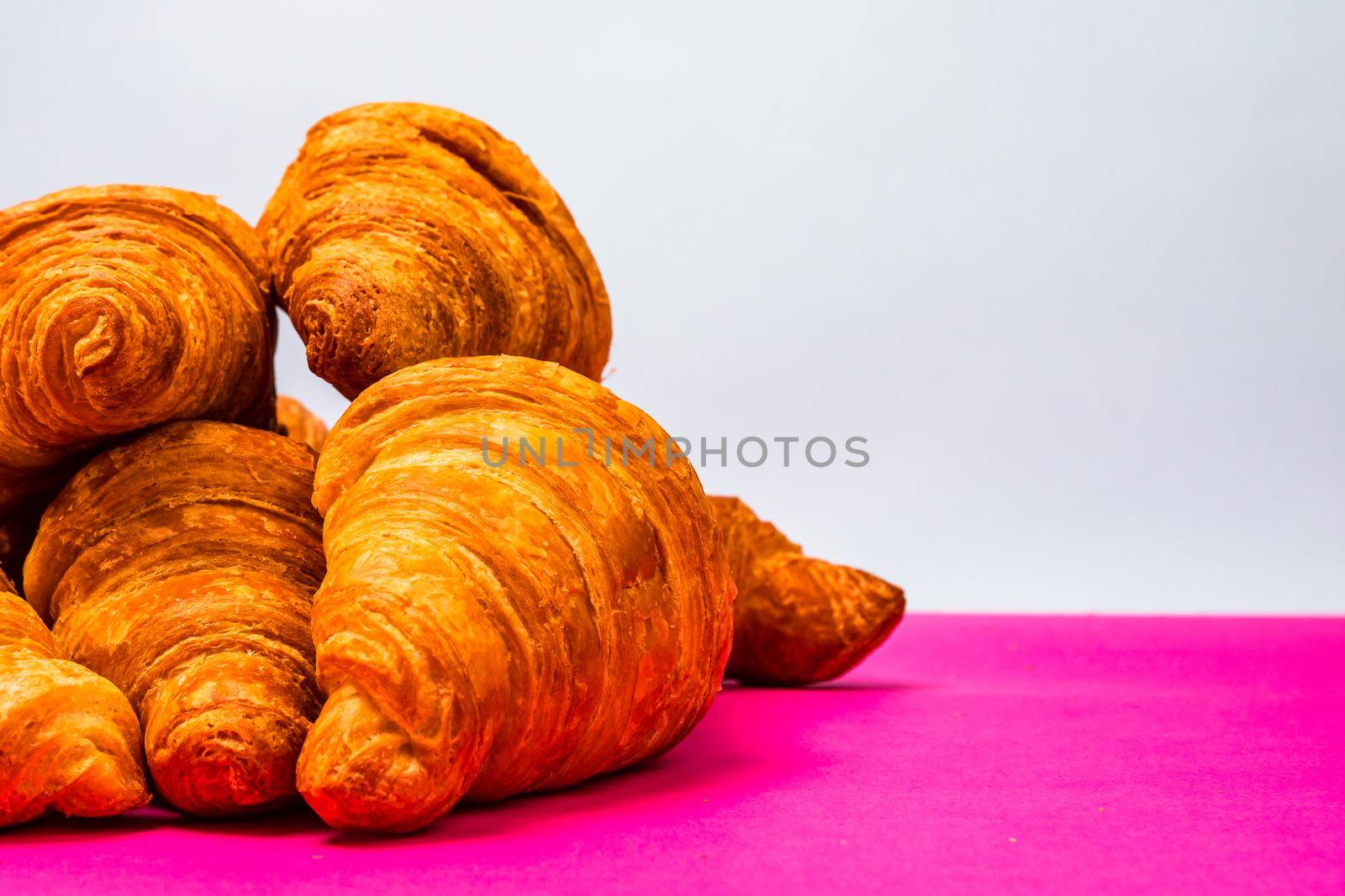 Fresh and delicious croissants isolated. French breakfast concept. by vladispas