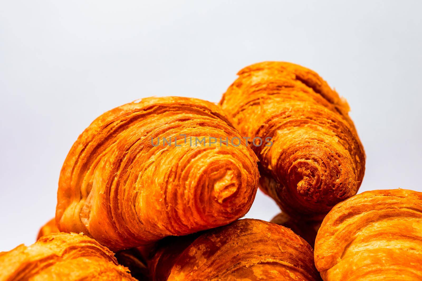 Fresh and delicious croissants isolated. French breakfast concept. by vladispas