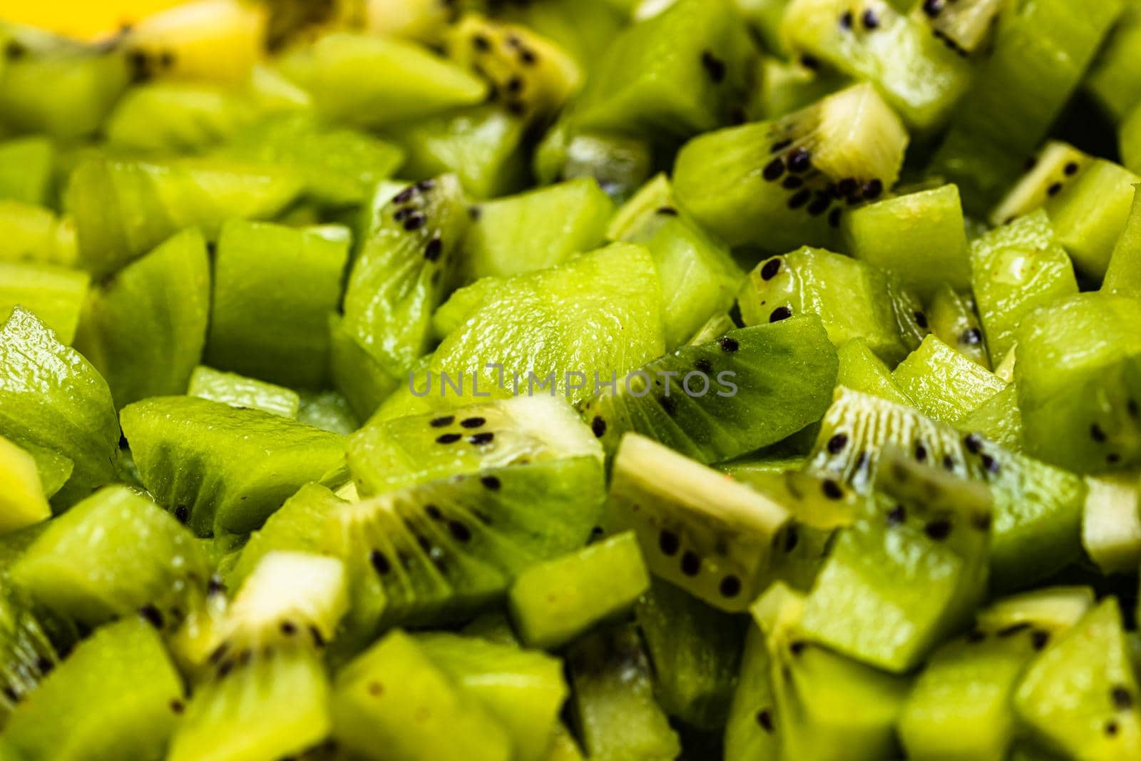 Ripe kiwi fruit. Detail of chopped exotic kiwi fruits used for desserts by vladispas