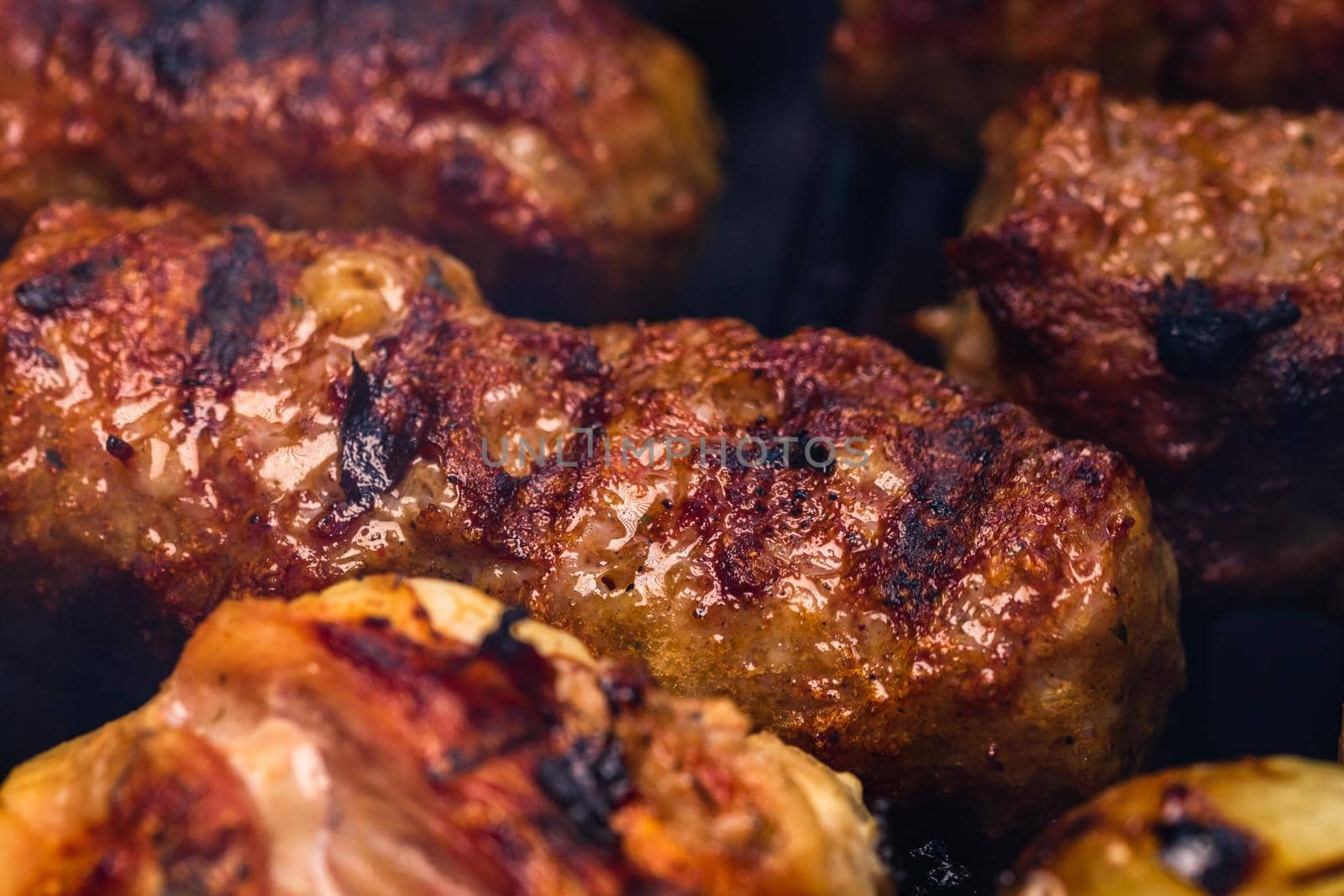 Traditional Romanian food Meat Balls "mici" on grill. Tasty meat balls on barbeque, pork meat on charcoal barbecue by vladispas