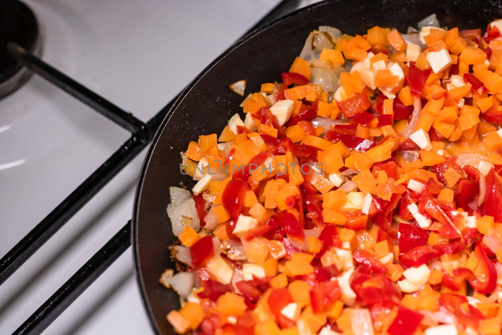 Preparation of soup with chicken and vegetables. Close up of frying vegetables, selective focus. by vladispas