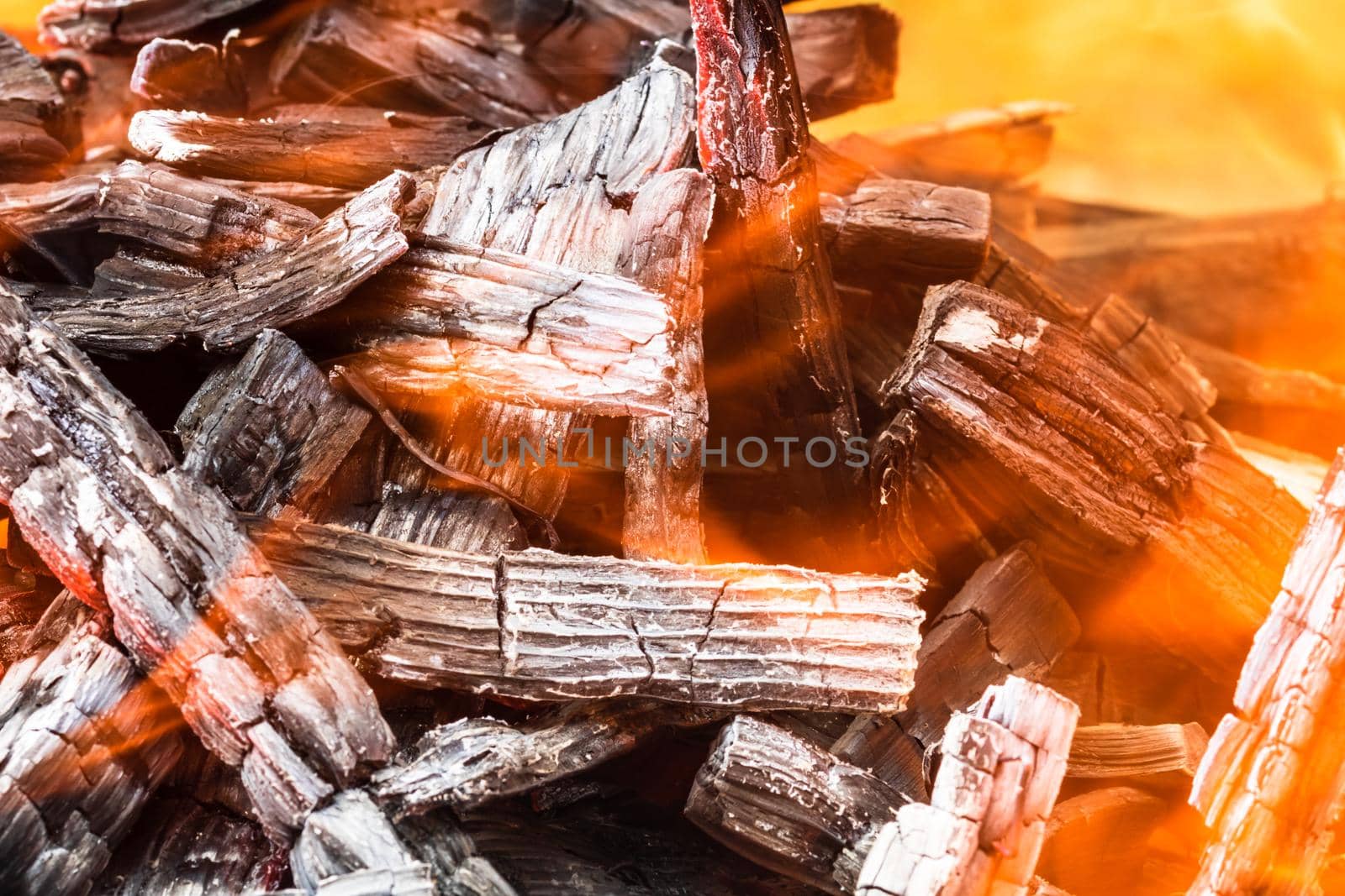 Burning wood chips forming coal. Barbecue preparation, fire before cooking. Hot coal made of greatly heated wood.