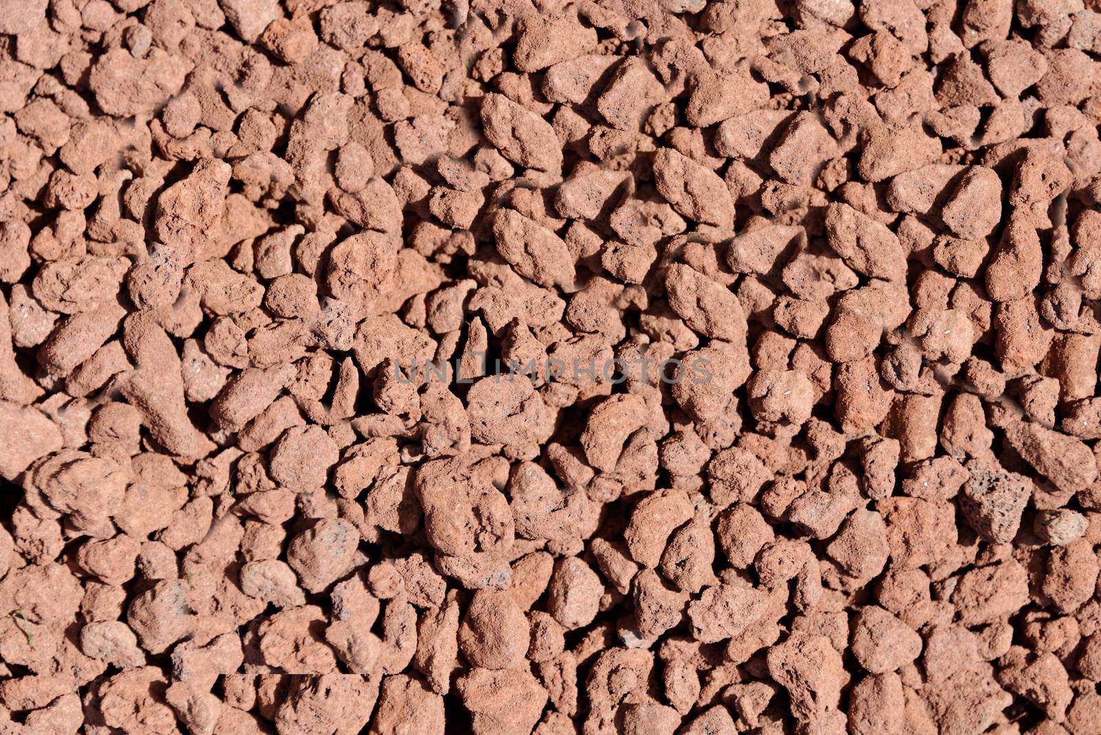 Thermal expanded clay pebbles are used as a nutrient medium in hydroponics. Background close-up of pellets.