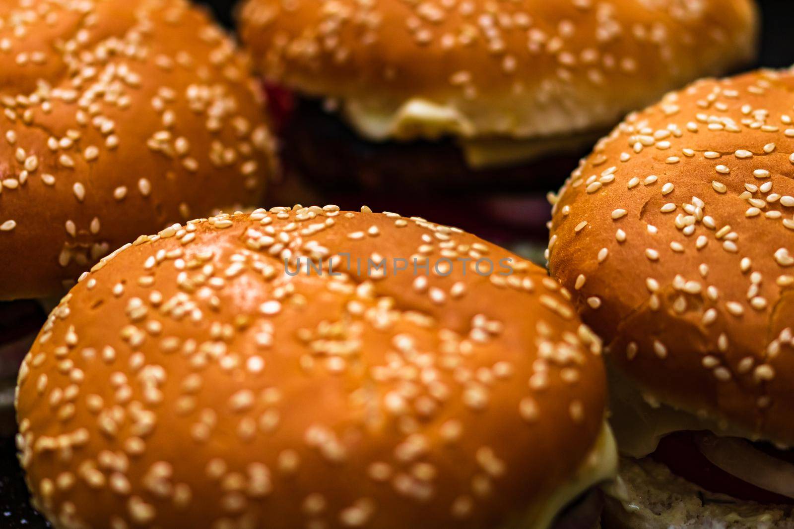 Closeup of fresh homemade tasty burgers on wooden table by vladispas