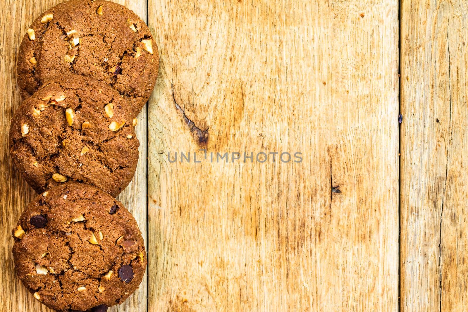 Biscuits on wooden table. Chocolate cookies on the table, breakfast concept. Top view with copy space by vladispas