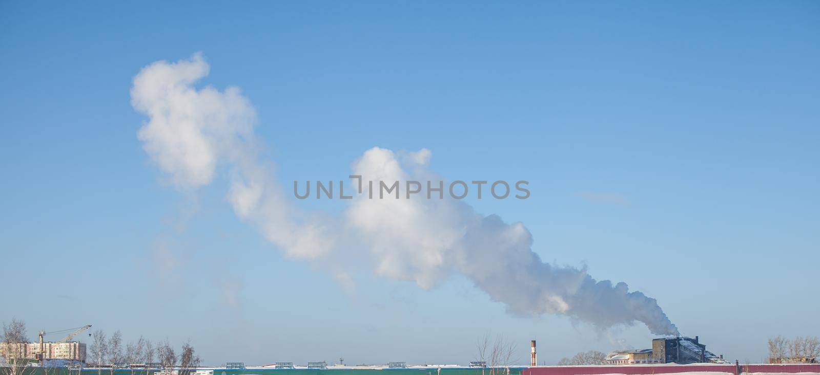 White thick smoke from the boiler room chimney. Industrial zone. by AnatoliiFoto