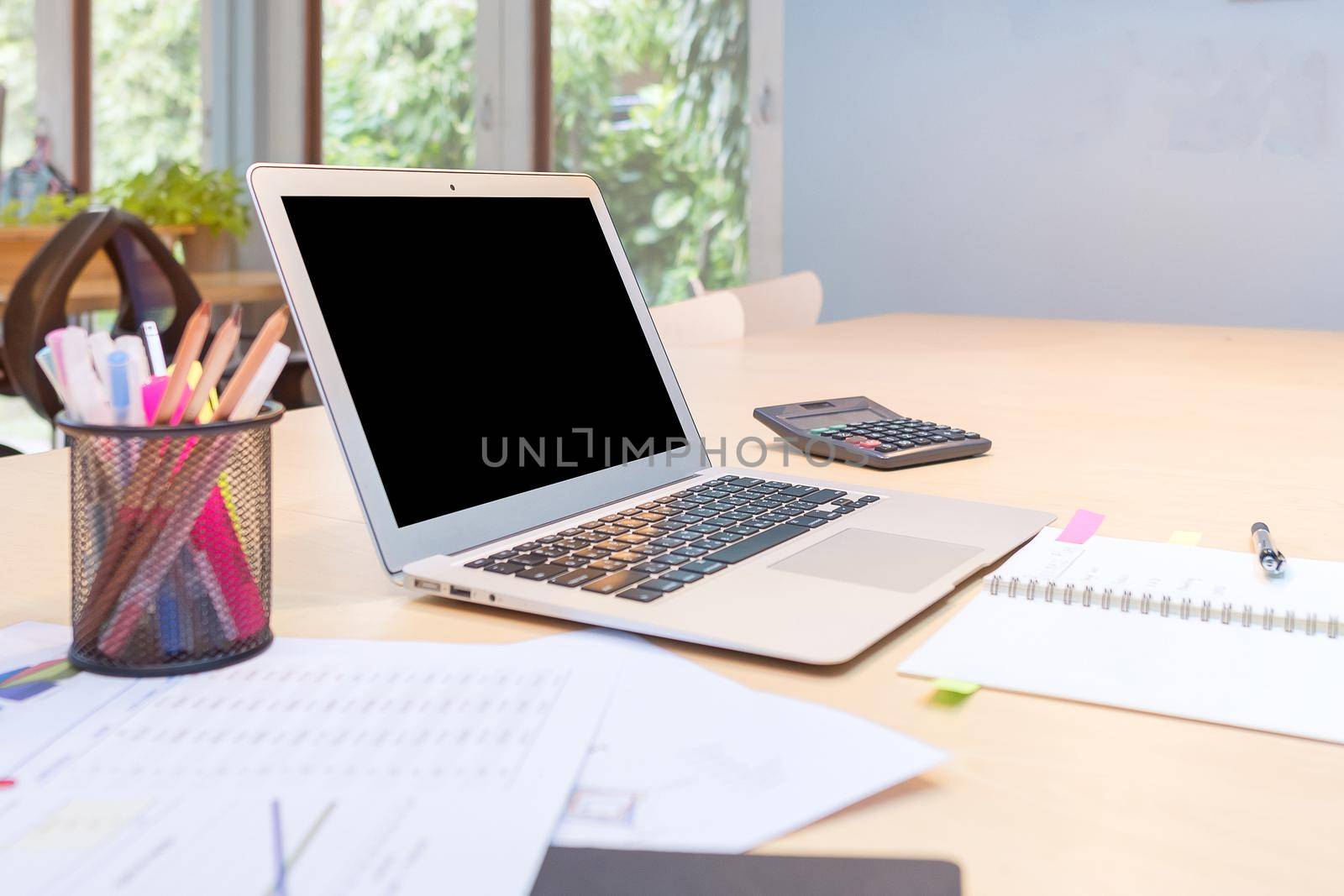 Smart modern laptop with blank screen on wooden table in Co Working Space,new working office style for startup business entrepreneur and freelance by Nuamfolio