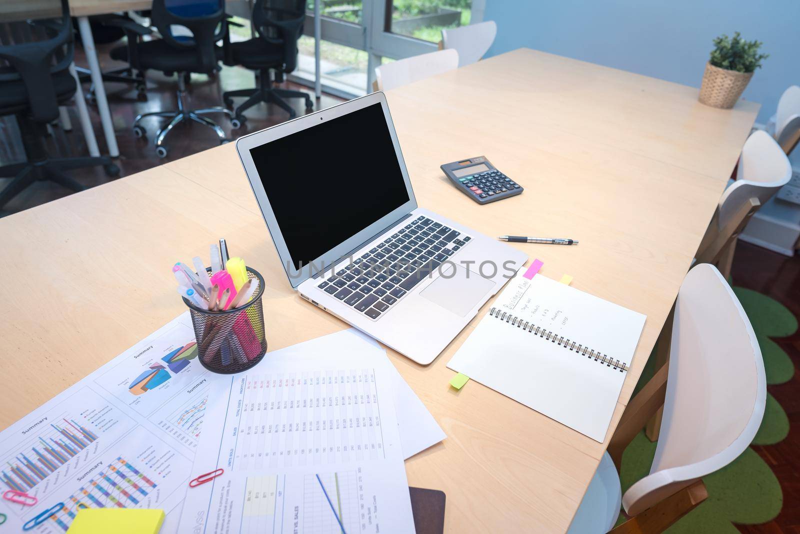 Smart computer and document put on wooden table in Co Working Space, new working office style for startup business owner and freelance.