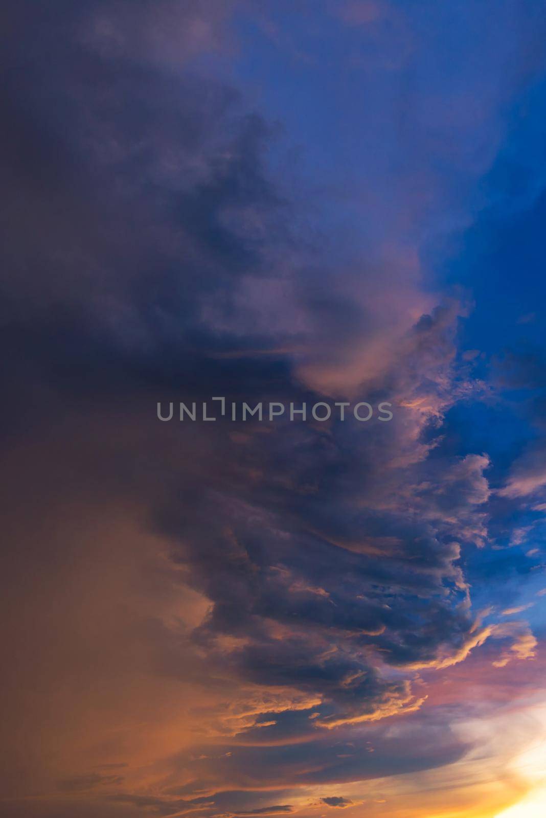 Dramatic sky with storm cloud before raining during sunset. by Nuamfolio