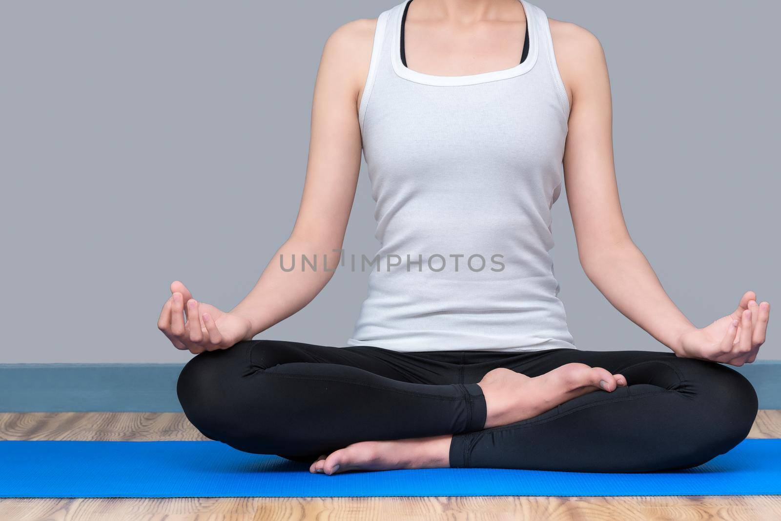 Young woman keep calm and meditates while practicing yoga to explore the Inner Peace. Yoga and meditation have good benefits for health. Photo concept for Yoga Sport and Healthy lifestyle. by Nuamfolio