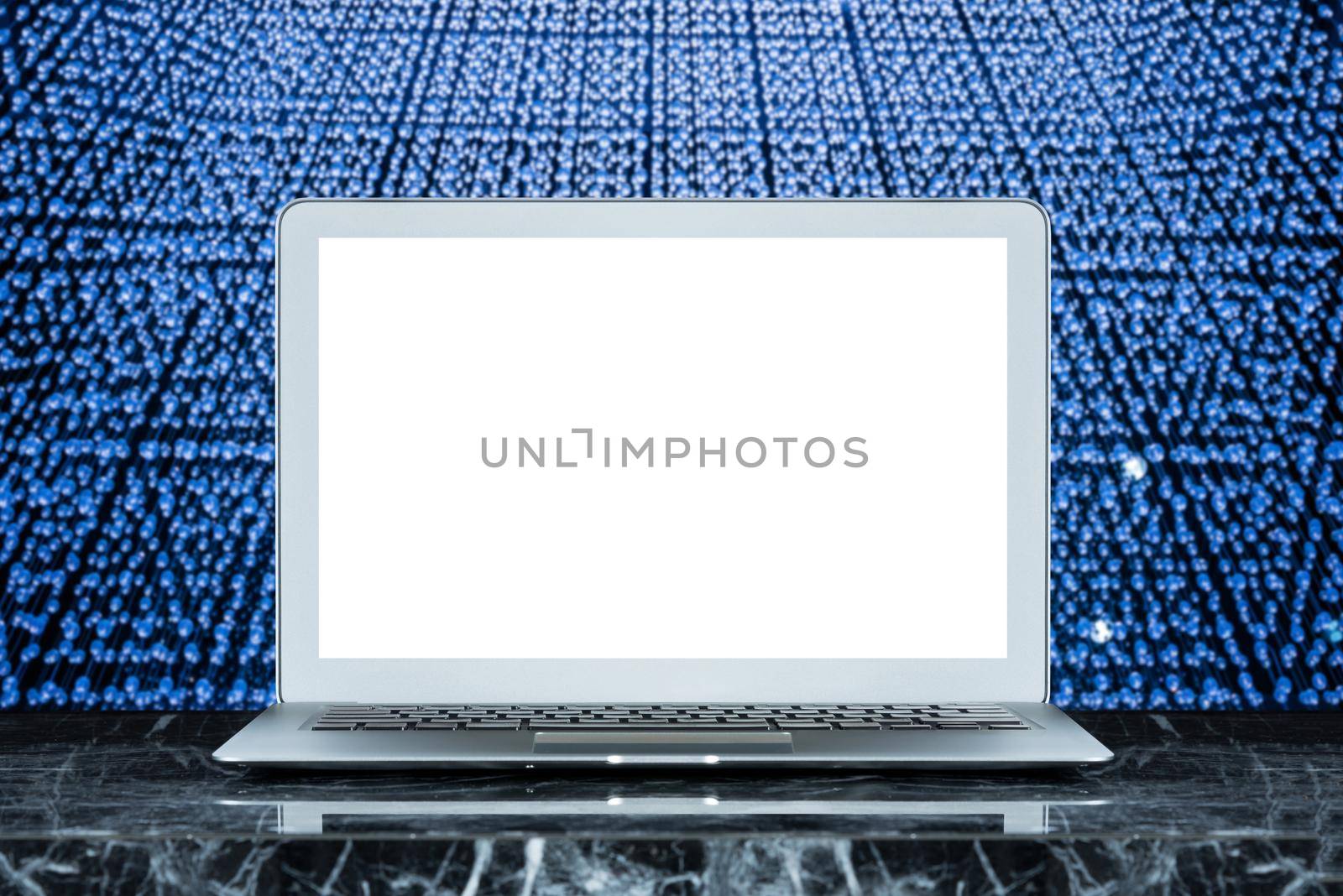 Smart modern laptop with white blank screen on marble table and bokeh background. Elegant Design with copy space for placement your template mock up.