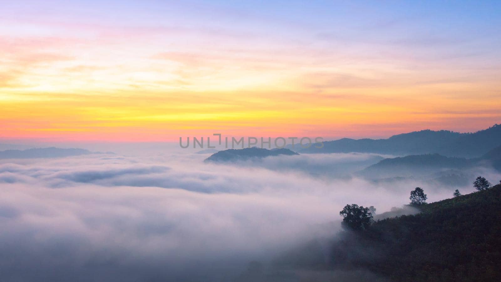 Panorama view of amazing mist moving over the nature mountains during sunrise at mountains area in Thailand. by Nuamfolio