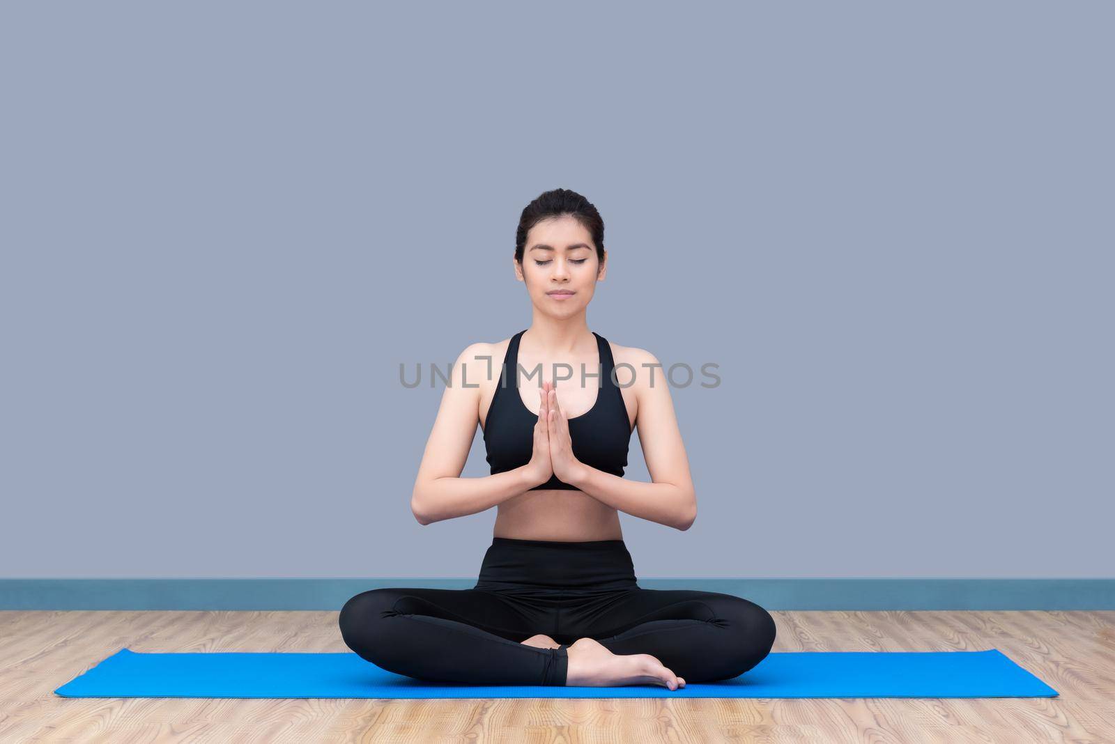 Asian woman keep calm and meditates while practicing yoga to explore the Inner Peace. Yoga and meditation have good benefits for health. Photo concept for Sport and Healthy lifestyle.