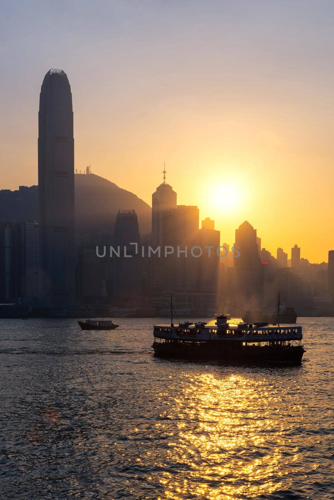 Hong kong traditional wooden chinese boat for tourist service in victoria harbor at sunset view from Kowloon side at Hong Kong