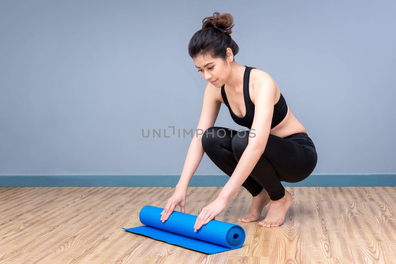 Healthy woman exercising yoga at sport gym, girl doing sport indoor.Photo design for fitness sporty woman and healthcare concept.