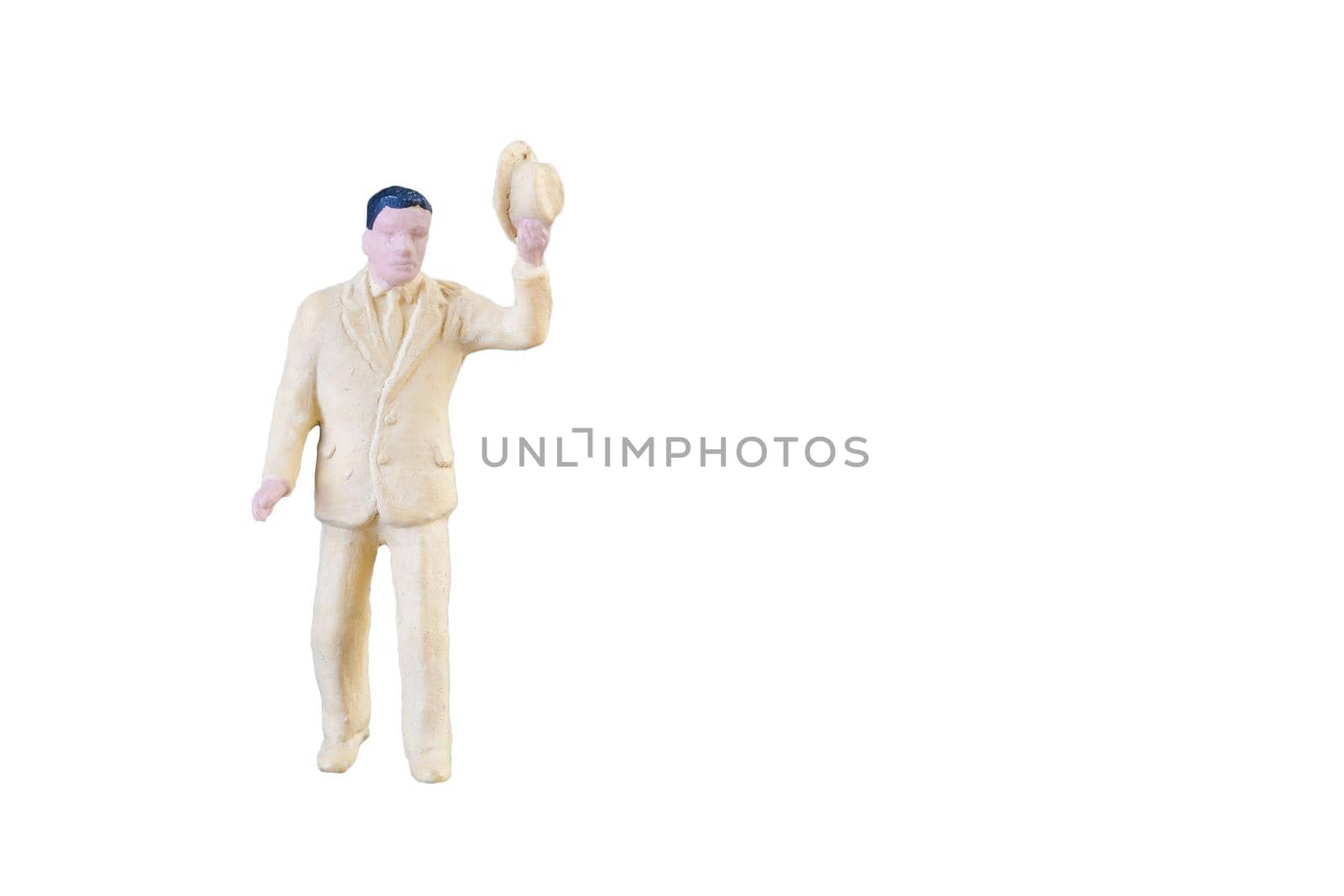 Close up of Miniature people isolated with clipping path on white background. by Nuamfolio
